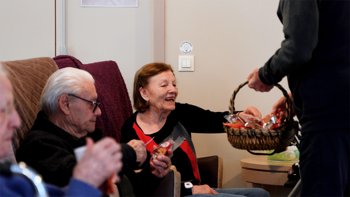 Elderly woman reaching for snacks from basket