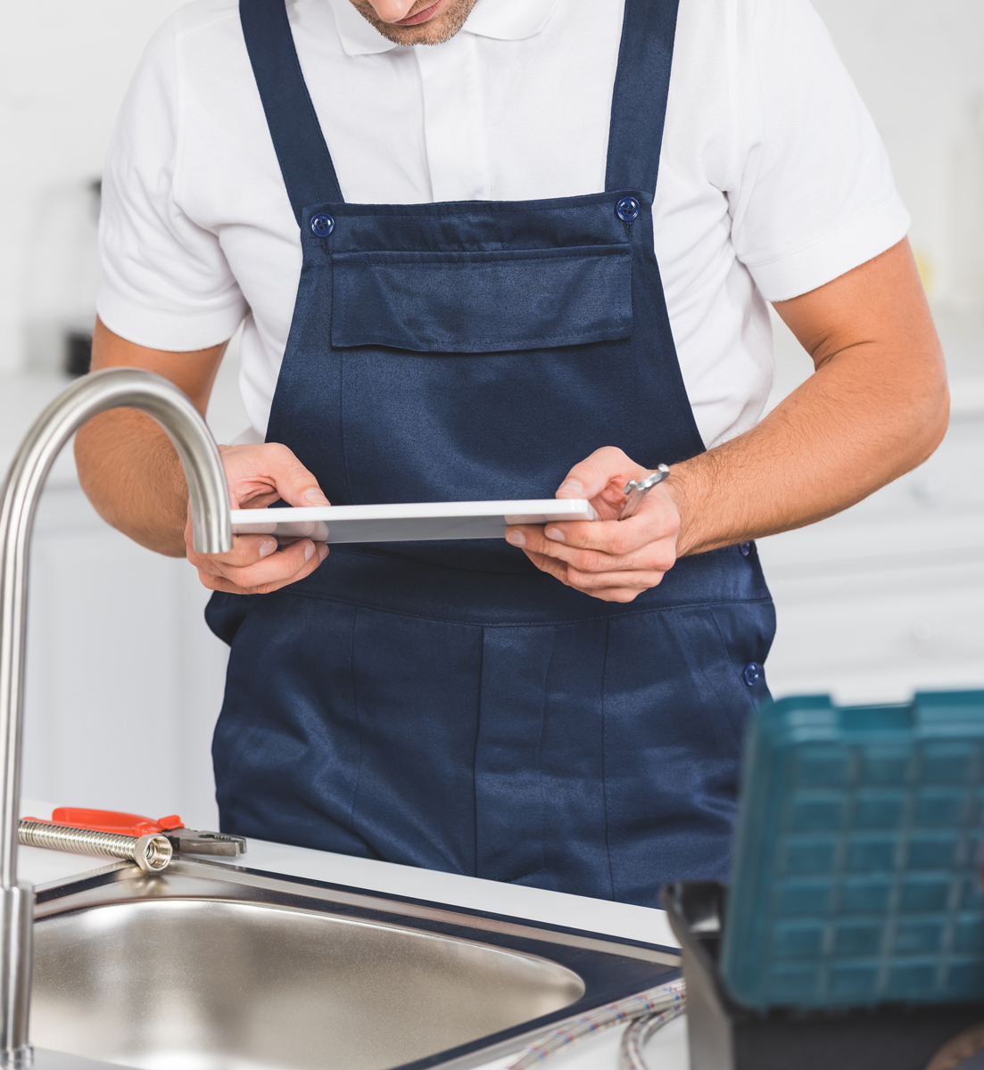 Plumber inspecting kitchen faucet installation